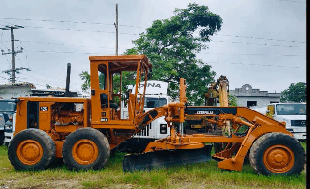 a caterpillar tractor is parked in the grass