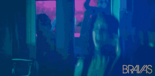 a woman wearing headphones in a dark room with the words bravas on the bottom