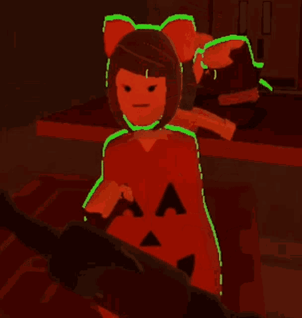 a girl in a pumpkin costume is holding a bat in a dark room .