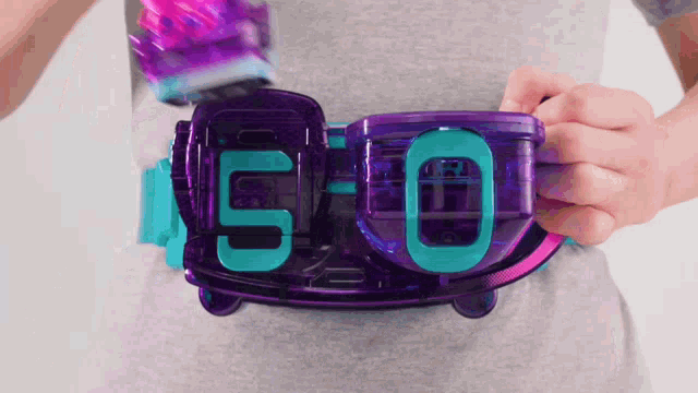 a person is wearing a purple belt with the number 50 on it .