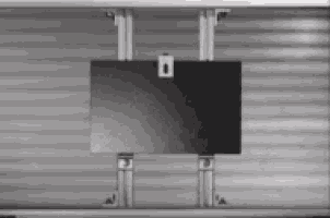 a black item is hanging from a metal frame