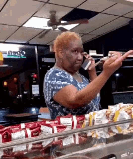 a woman is talking on a cell phone in a store