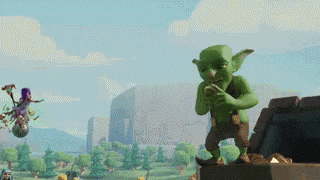 a green goblin standing on top of a pile of rocks