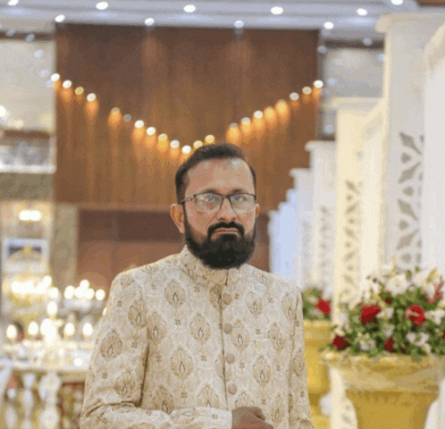 a man with a beard wearing glasses and a white jacket