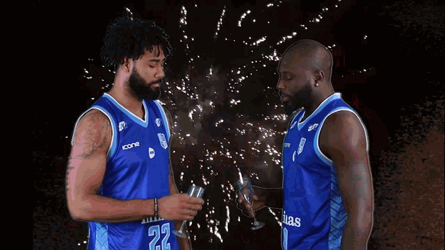 two basketball players wearing blue jerseys that say minas on them