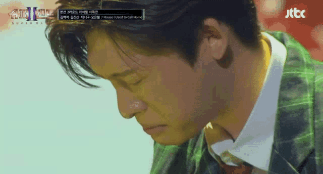 a close up of a man 's face with a jtbc logo in the corner