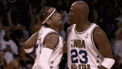 a couple of basketball players are standing next to each other on a court .