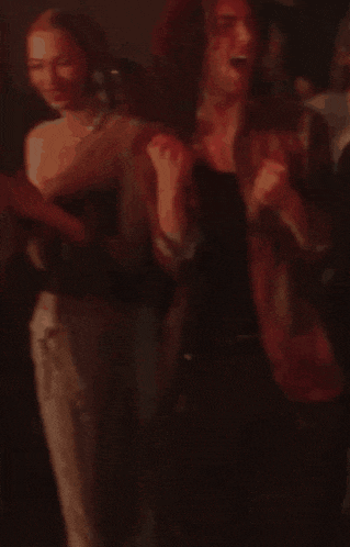 a man with a tattoo on his arm is dancing in a dark room