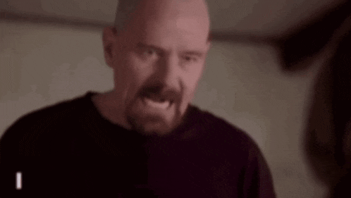 a bald man with a beard and mustache is making a funny face .
