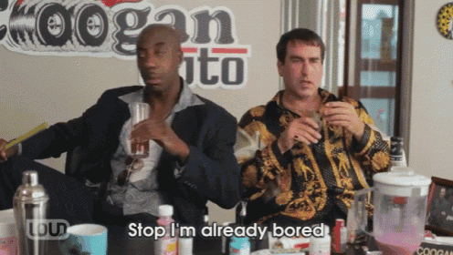 two men are sitting at a table with a sign that says cogan ito