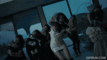 a gif from gifrun.com shows a person holding a heart shaped object