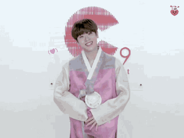 a young man in a pink kimono stands in front of a sign that says 9