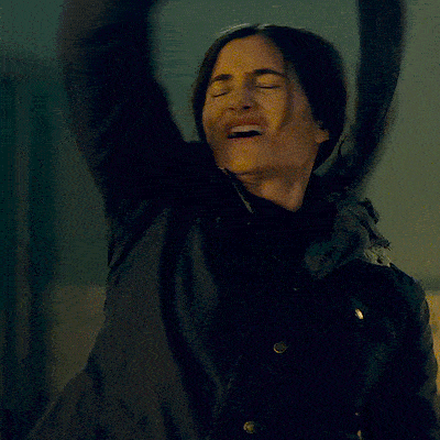 a woman in a black jacket is making a funny face and the caption says is it hot