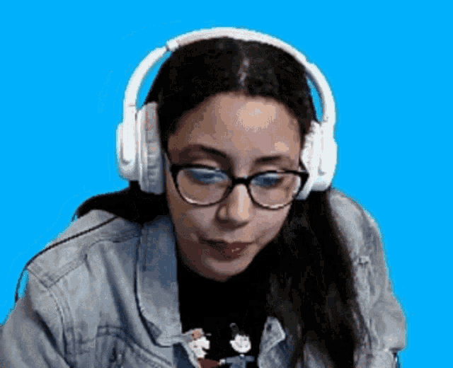 a woman wearing headphones and glasses on a blue background