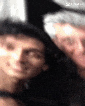 a blurred image of two men with the caption capcut