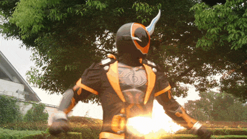 a man in a superhero costume is standing in front of trees
