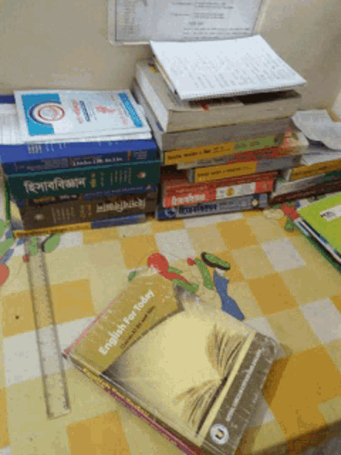 a book titled english for today sits on a table with other books