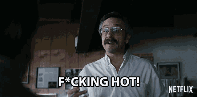 a man with glasses and a mustache says " f * cking hot "