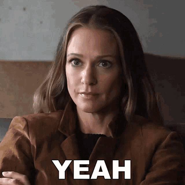 a woman with her arms crossed and the word yeah on her face