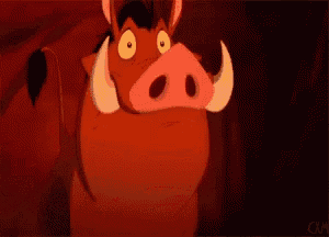 a cartoon warthog from the lion king is standing in a cave with its mouth open .