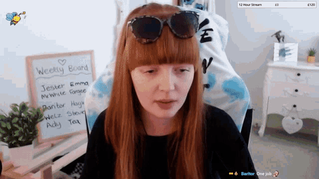 a woman wearing sunglasses stands in front of a weekly board that says jester emma