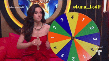 a woman in a red dress is holding a colorful spinning wheel with the number 3 on it