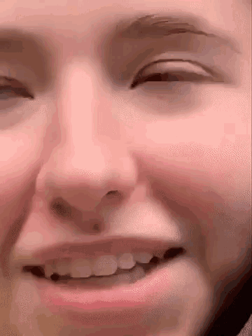 a close up of a person 's face with their eyes closed and their mouth open .
