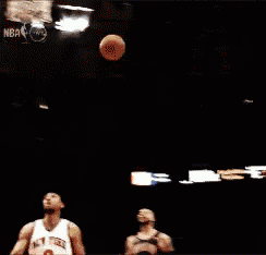 a basketball player going for a dunk in front of a sign that says 15