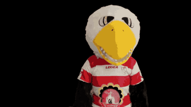 a mascot wearing a red and white striped shirt with legea on the front