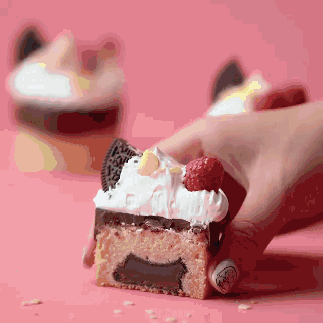 a person is holding a piece of cake with oreos on top