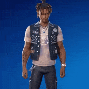 a man with dreadlocks is wearing a vest and a t-shirt .