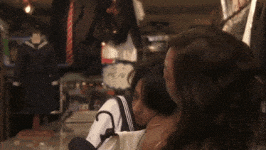 two women are standing next to each other in a store