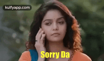 a woman is talking on a cell phone with the words `` sorry da '' written on her face .
