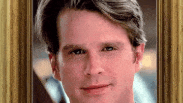 a close up of a man 's face in a framed picture .