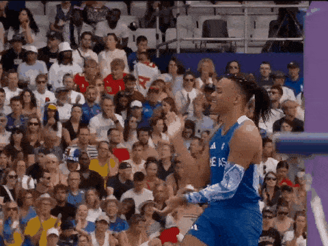 a basketball player wearing a blue jersey that says texas