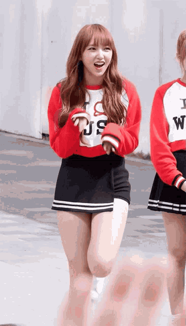 a girl wearing a red sweater that says i love us on it