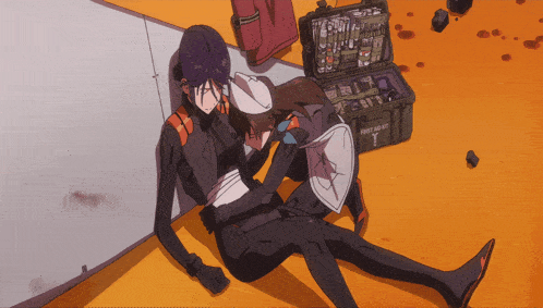 a person laying on the ground with a first aid kit in the background