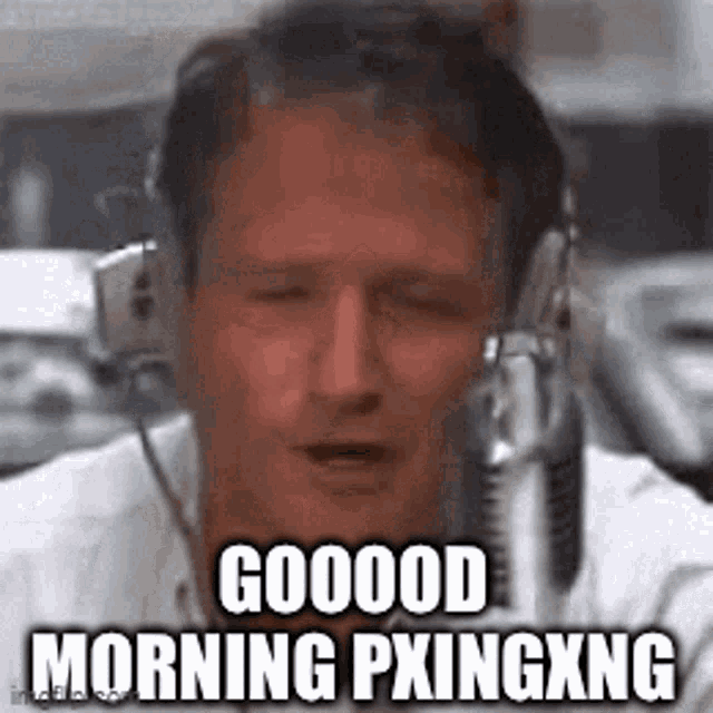 a man wearing headphones is talking into a microphone and saying `` good morning pxingxng '' .
