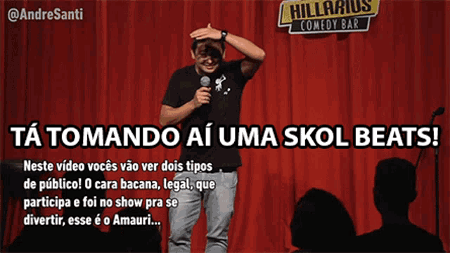 a man stands on a stage with a microphone in front of a red curtain that says hilarious comedy bar