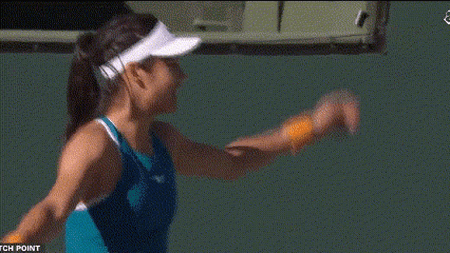a woman wearing a white nike hat looks down