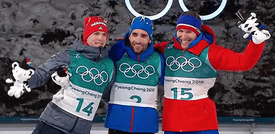 three men are posing for a picture with one wearing the number 15