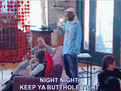 a man in a blue shirt is standing in front of a group of people and says night night keep ya butthole tight .