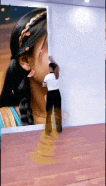 a woman is standing in front of a wall with a picture of her on it