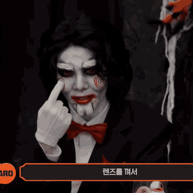 a man dressed up as a puppet with chinese writing on the bottom right