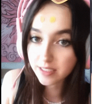 a close up of a woman 's face wearing headphones