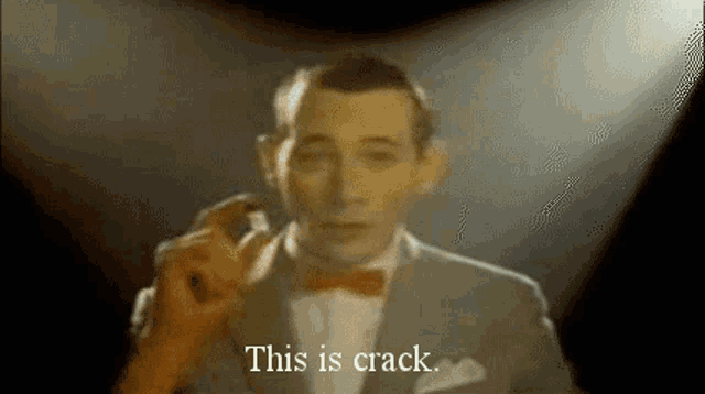 a man in a suit and bow tie is standing in front of a microphone and says `` this is crack '' .