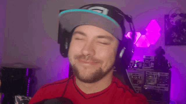 a man wearing headphones and a hat with a g on it