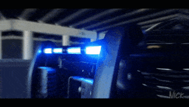 a close up of a blue light on a vehicle with nick written on the bottom