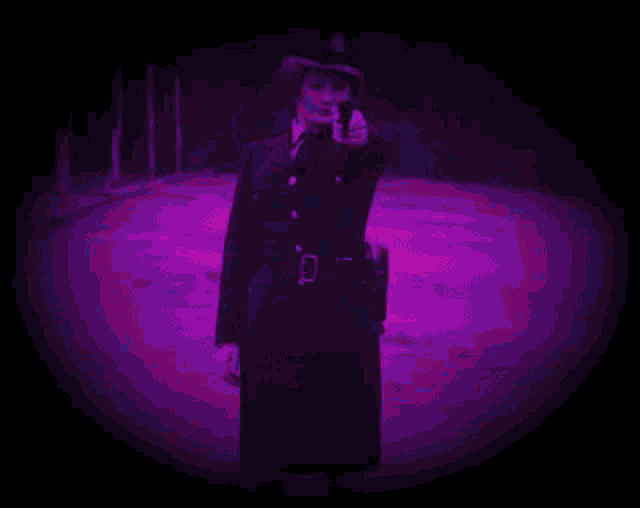 a woman in a police uniform pointing a gun at the camera