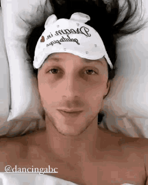 a man is wearing a sleep mask that says dancing